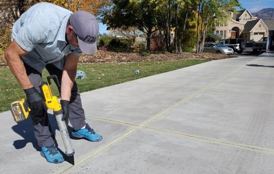 Man Applying Grout To Driveway