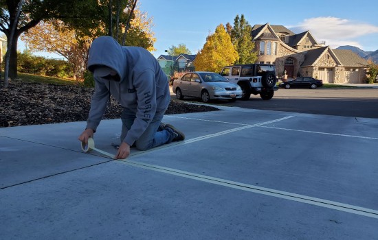 Man Taping Driveway